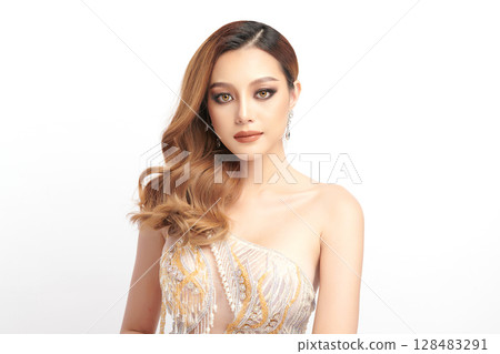 A beautiful young Asian woman with clean, fresh skin against a white background. Skincare, facial treatment, cosmetology, beauty, and spa. An elegant portrait of an Asian woman. 128483291