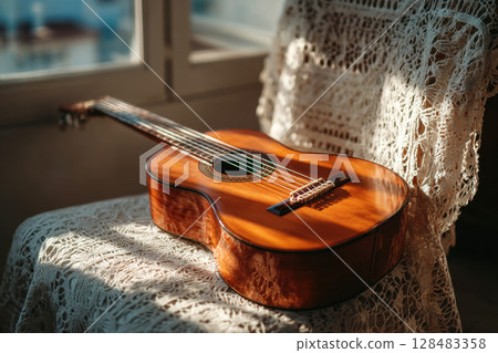 Acoustic guitar on chair, close up 128483358