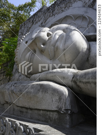 Fragment of statue of lying Buddha at Long Son Pagoda in Nha Trang, Vietnam 128484633