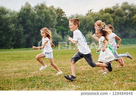 Running, active time spending. Kids are having fun on the field at daytime together 128484848