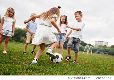 Kids are having fun on the field at daytime together Kids are having fun on the field at daytime together 128484865