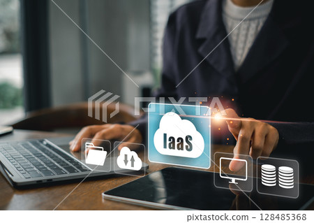 Business professional interacts with IaaS cloud interface, showcasing modern technology in a contemporary office environment. 128485368