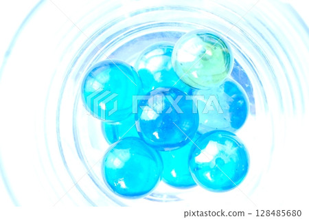 Wine glasses and marbles by the window 128485680