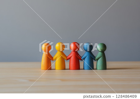 Wooden Figures. A row of colorful human figures stand together, symbolizing of diversity. Importance of inclusion, teamwork. People Silhouettes. Concepts of unity in our society. Humanity. Copy Space Wooden Figures. A row of colorful human figures stand together, symbolizing of diversity. Importance of inclusion, teamwork. People Silhouettes. Concepts of unity in our society. Humanity. Copy Space 128486409