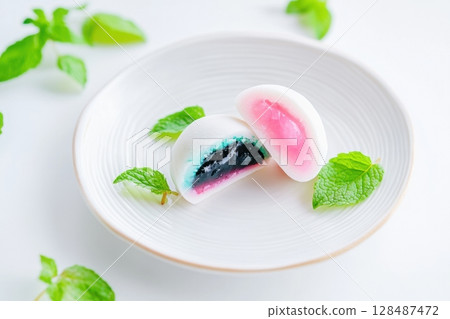 Delicious Japanese moti desserts. Close up. Asian rice daifuku dessert sweet mochi. Cut in half with filling. Traditional dessert mochi ice cream. Colorful rice cake. Fukashi manju. Culinary delights Delicious Japanese moti desserts. Close up. Asian rice daifuku dessert sweet mochi. Cut in half with filling. Traditional dessert mochi ice cream. Colorful rice cake. Fukashi manju. Culinary delights 128487472