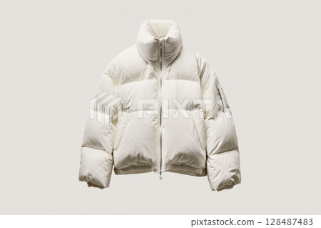 Front view of trendy winter jacket. Blank white down jacket with zipped hanging on white wall. Mockup for design. Warm Puffer Hanging On Wall. Fashion clothes. Fall apparel. Modern youth urban wear. 128487483