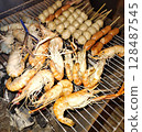 grilled shrimps on the flaming grill 128487545