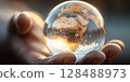 Holding a glowing earth globe in  hand 128488973