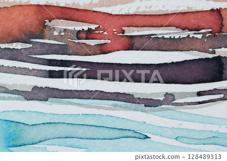 Abstract ink patterns creating a vibrant blend of colors on textured paper in a creative workspace 128489313