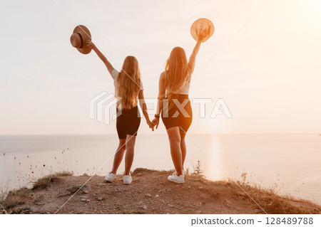 Two Women Enjoying a Sunset View 128489788