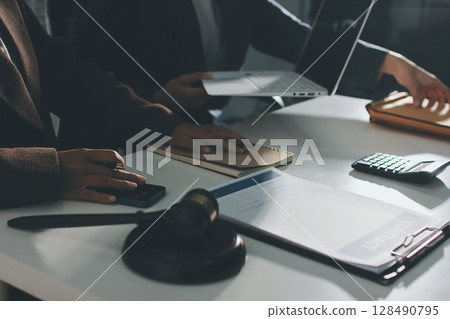Lawyer explained to the client about the law that must be brought against the court case. Lawyer explained to the client about the law that must be brought against the court case. 128490795