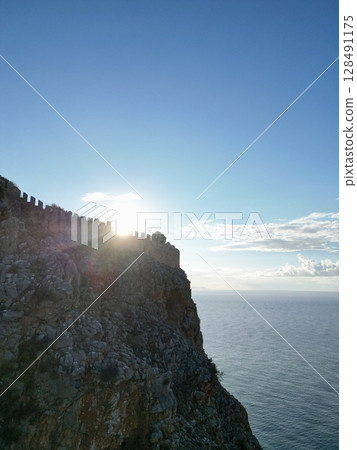 fortress on a rock near the sea coast 128491175