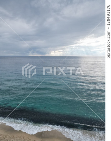 Sunset ocean waves. Sunset ocean horizon. High quality 4k footage 128491176