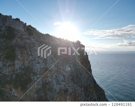 fortress on a rock near the sea coast 128491191