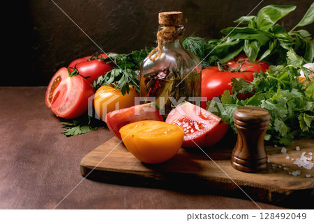 Fresh Tomatoes Herbs Oil Cutting Board Fresh Tomatoes Herbs Oil Cutting Board 128492049