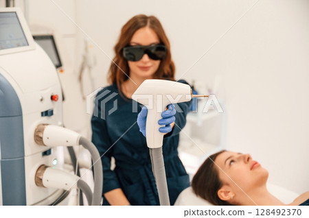 Getting photo rejuvenation procedure at cosmetology clinic. Woman is getting LPG hardware massage in beauty salon 128492370