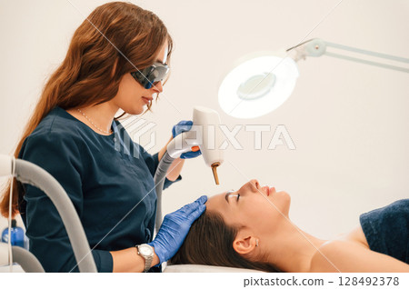 Conception of beauty. Getting photo rejuvenation procedure at cosmetology clinic Conception of beauty. Getting photo rejuvenation procedure at cosmetology clinic 128492378