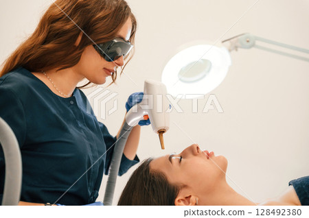 Conception of beauty. Getting photo rejuvenation procedure at cosmetology clinic Conception of beauty. Getting photo rejuvenation procedure at cosmetology clinic 128492380