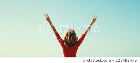 Summer vacation, happy inspired young woman raising her hands up on the beach on sea and blue sky Summer vacation, happy inspired young woman raising her hands up on the beach on sea and blue sky 128492479