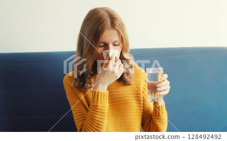 Sick exhausted young woman sneezing blow nose using tissue, unhealthy girl taking a medication Sick exhausted young woman sneezing blow nose using tissue, unhealthy girl taking a medication 128492492
