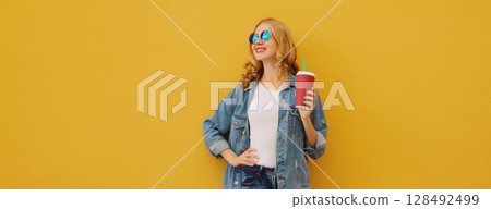 Summer joyful young woman with cup of coffee, stylish modern girl holding juice in casual clothes Summer joyful young woman with cup of coffee, stylish modern girl holding juice in casual clothes 128492499