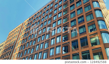 Architecture and real estate, modern residential apartment building with large panoramic windows Architecture and real estate, modern residential apartment building with large panoramic windows 128492588