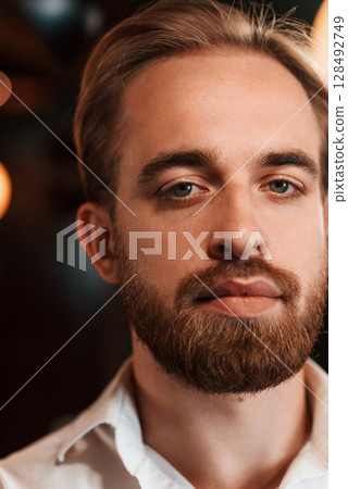 Portrait of handsome bearded man in white shirt 128492749