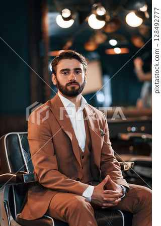 Handsome man with beard is in the barber shop 128492777