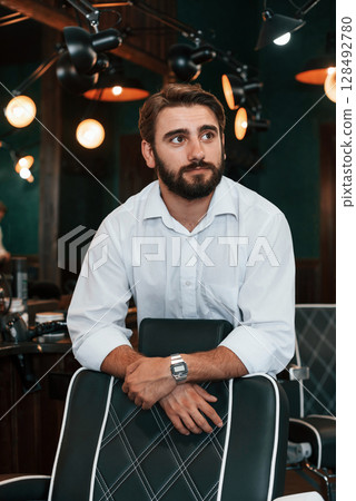Handsome man with beard is in the barber shop 128492780