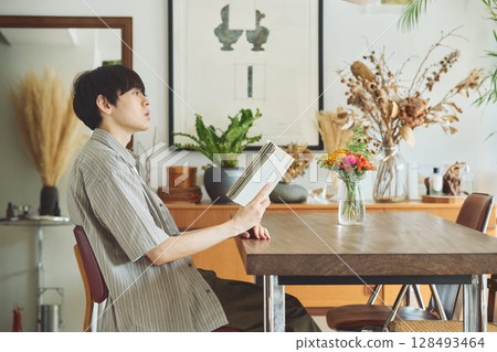 一個人在客廳裡看書 一個人在客廳裡看書 128493464