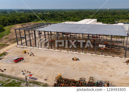 Building under construction, crane in action. 128493805