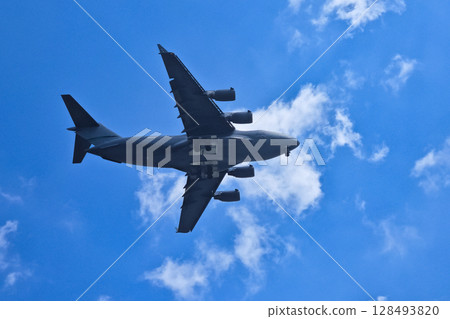 Large airplane soaring through a clear blue sky. Large airplane soaring through a clear blue sky. 128493820