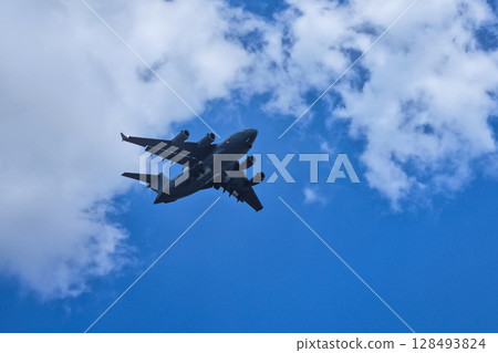 A plane gracefully soaring through the azure sky. A plane gracefully soaring through the azure sky. 128493824