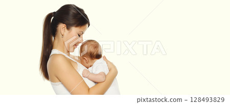 Happy young mother kissing baby on white studio background Happy young mother kissing baby on white studio background 128493829