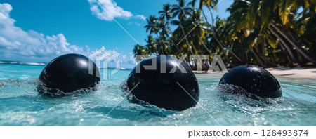 Three black balloons floating near tropical beach with palm trees, summer holiday concept 128493874