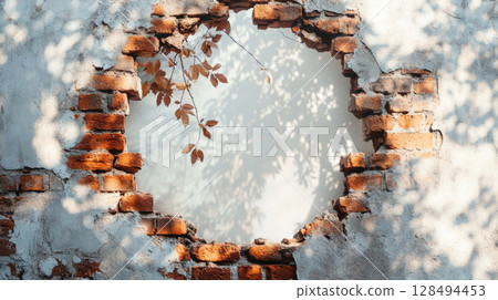 Brick wall with circular hole and vine branches, rustic concept 128494453