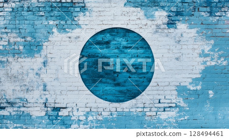 Blue circle on a distressed blue and white brick wall 128494461