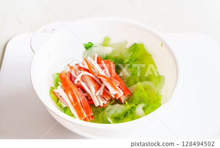 Salted lettuce and crab sticks 128494502