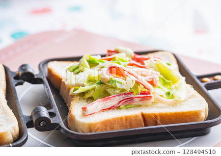 Making hot sandwiches with crab stick salad Making hot sandwiches with crab stick salad 128494510