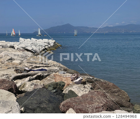 Sestri Levante, Italy - July 15, 2025. Sailboats in sea. Sport and sailing school for teenagers and adults. Nature and vacation in Italy. Leisure and seasons. Sestri Levante, Italy - July 15, 2025. Sailboats in sea. Sport and sailing school for teenagers and adults. Nature and vacation in Italy. Leisure and seasons. 128494968