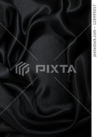 Smooth elegant black silk or satin luxury cloth texture as abstract background. Luxurious background design Smooth elegant black silk or satin luxury cloth texture as abstract background. Luxurious background design 128495057