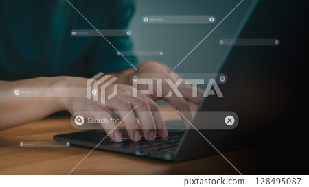 Focusing on a search bar with a magnifying glass icon. Concept of represents online searching, research, and digital information gathering. Male hand types on a laptop keyboard. 128495087