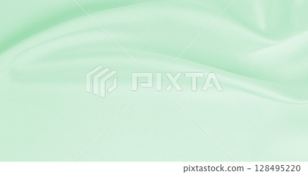 Smooth elegant green silk or satin luxury cloth texture as abstract background. Luxurious background design 128495220