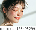 Natural beauty portrait of a smiling young woman with glowing skin 128495299