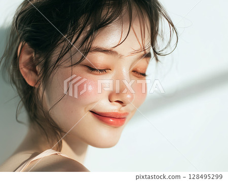 Natural beauty portrait of a smiling young woman with glowing skin 128495299