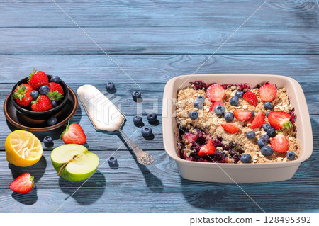 apple blueberry strawberry crumble in baking dish 128495392