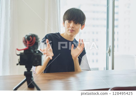 A young man shooting a video A young man shooting a video 128495425