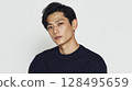 Upper body of a young man in a sweater photographed against a white background | A trusting expression 128495659