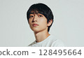 The silent gaze of a clear-skinned young man in a white T-shirt | Studio shot 128495664
