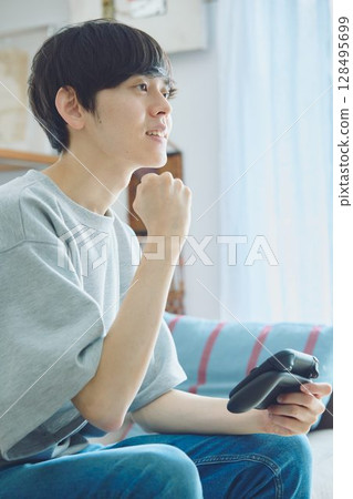 Man playing games in the living room 128495699